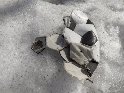 Torn Football in the Snow
