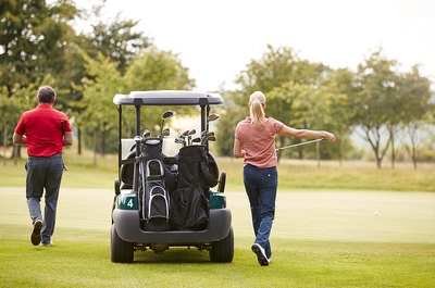 Man Woman Golf Buggy