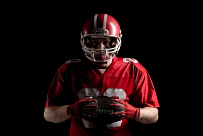 American Football Player Holding the Ball